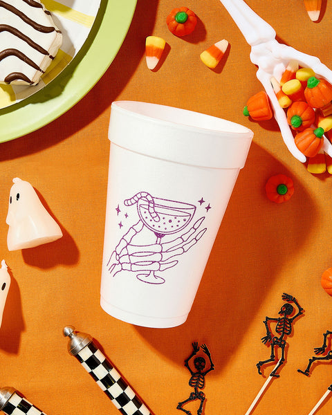 halloween cocktail with skeleton hand on styrofoam cup